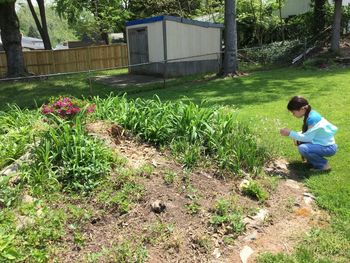 Side view of woman sitting on grass