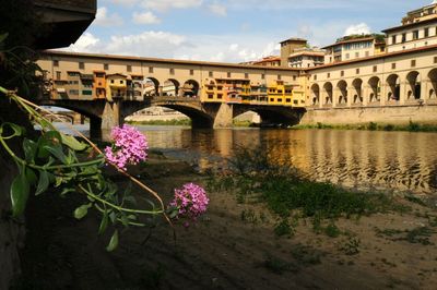 View of bridge over river with buildings in background