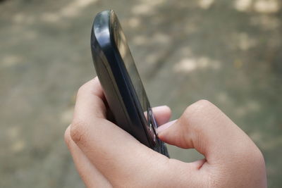 Close-up of woman hand holding smart phone