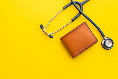 High angle view of electric lamp against yellow background