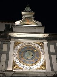 Low angle view of clock tower against building