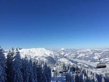 Scenic view of snowcapped mountains against clear blue sky