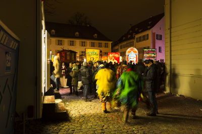 People walking on street in city at night