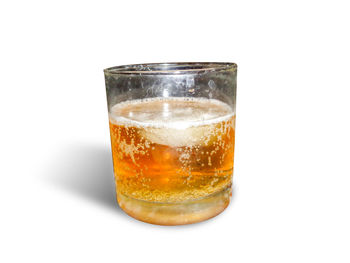 Close-up of beer glass against white background