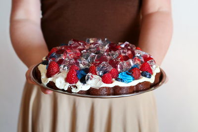 Close-up of hand holding cake