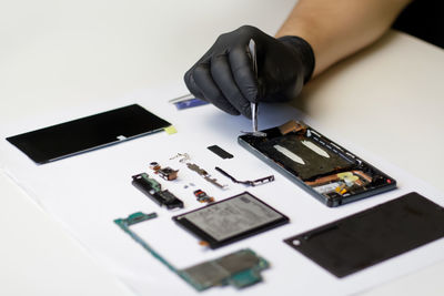 Technician repairing the smartphone's motherboard in the lab. mobile phone, electronic, repairing