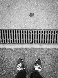 Low section of man standing on tiled floor