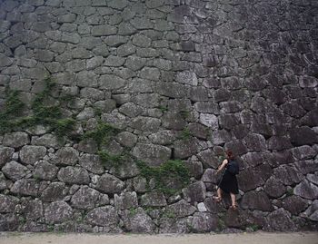 Full length of woman walking on rock