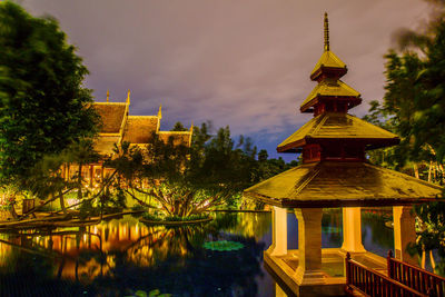 View of illuminated building against cloudy sky