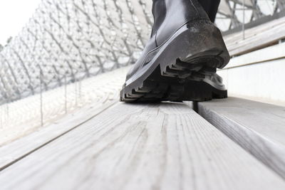 Low section of man standing on wooden floor