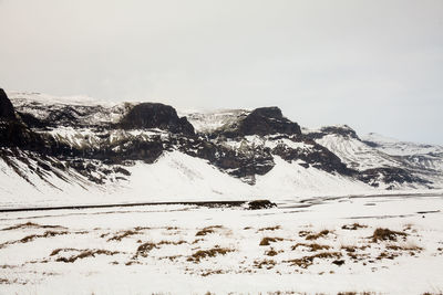 Scenic view of snowcapped mountains against clear sky