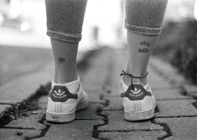 Low section of man standing on footpath