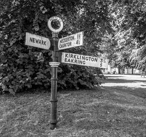 Close-up of road sign against trees