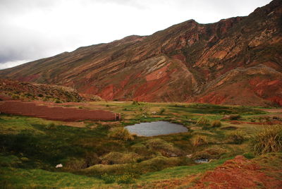 Scenic view of mountains against cloudy sky