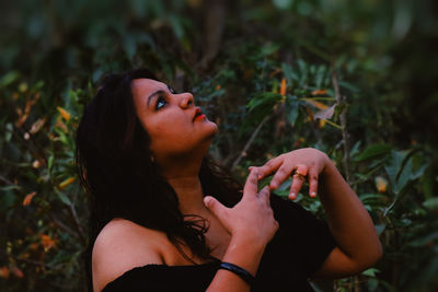 Portrait of young woman looking up