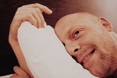 Close-up of man relaxing on bed