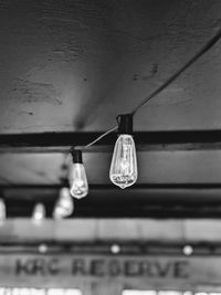 Low angle view of light bulbs hanging from ceiling