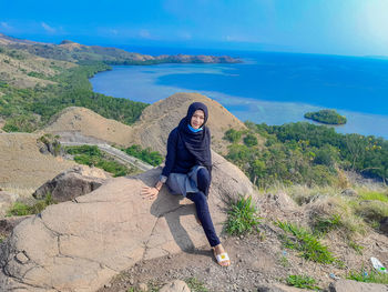 Rear view of woman standing on mountain