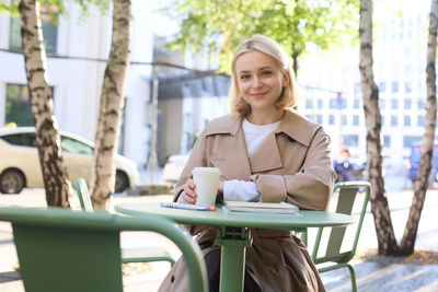 Young woman using laptop at table