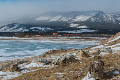 Scenic view of snowcapped mountains by lake against sky