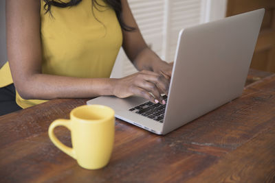 Hands of a businesswoman working on her laptop from home