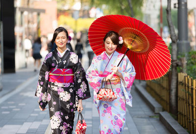 Portrait of smiling young woman in city