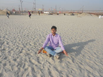 Portrait of woman sitting on beach