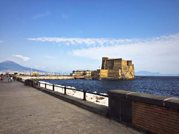 Castel dell ovo by sea against sky