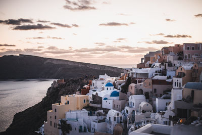 High angle view of townscape by sea against sky