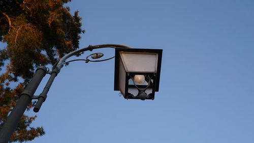 Low angle view of street light against clear blue sky