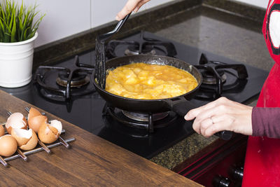 Midsection of woman preparing food in kitchen