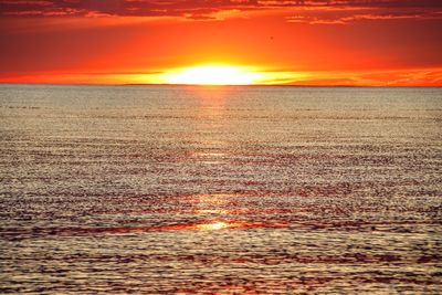 Scenic view of sea against romantic sky at sunset