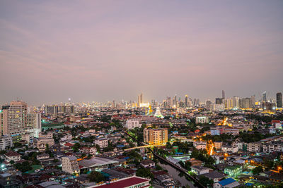 High angle view of illuminated buildings against sky during sunset