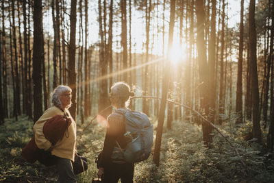 Two senior women hiking in forest