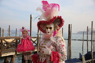 Rear view of woman standing by railing