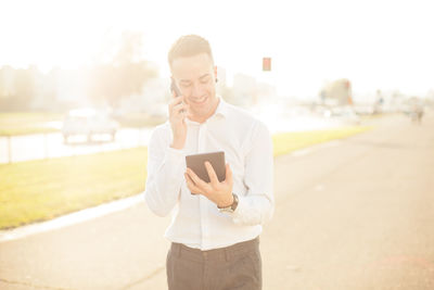Mid adult man using mobile phone