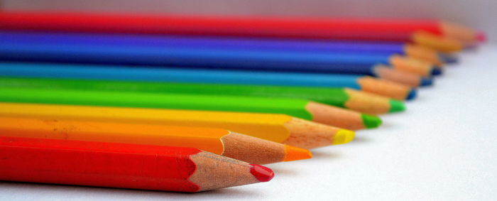 Close-up of colored pencils on white background