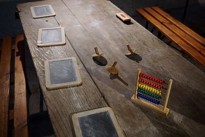 Abacus calculator and slate on table