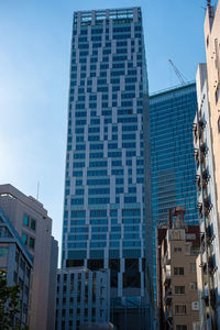 Low angle view of modern buildings against clear blue sky