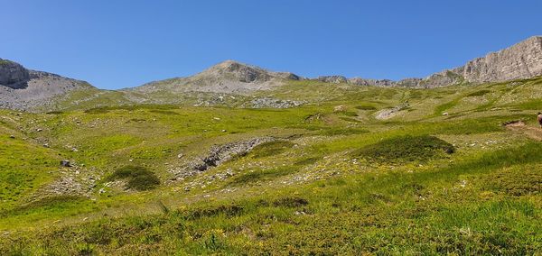Scenic view of mountains against clear blue sky