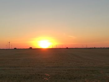 Scenic view of field against sky during sunset