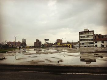 Reflection of cityscape in puddle