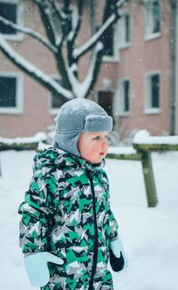 Cute boy standing in snow