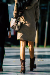 Low section of women walking on street