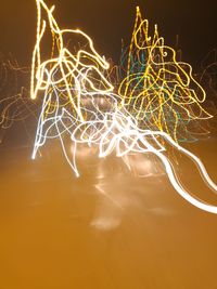 Close-up of light trails against sky at night