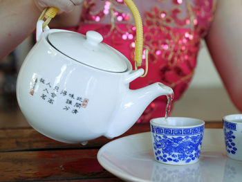 Close-up of hand holding tea cup