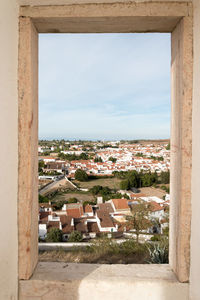 Cityscape against sky seen through window