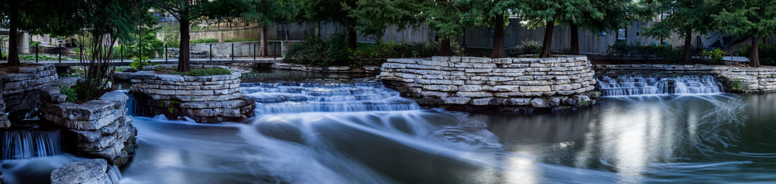 Panoramic shot of waterfall in forest