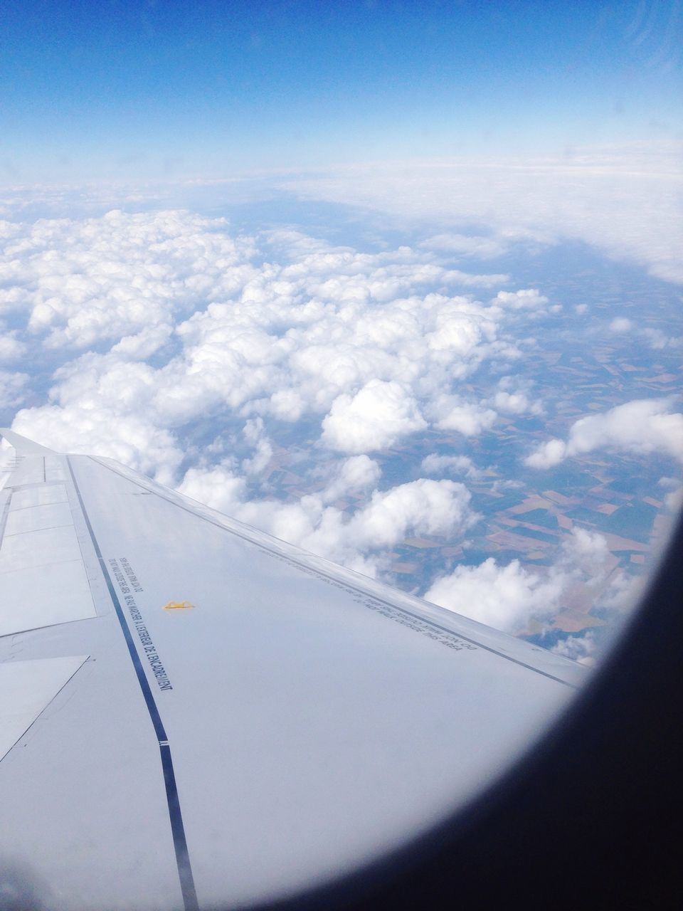 airplane, air vehicle, aircraft wing, transportation, flying, aerial view, part of, cropped, sky, mode of transport, cloud - sky, travel, journey, mid-air, cloud, blue, landscape, on the move, vehicle interior, glass - material