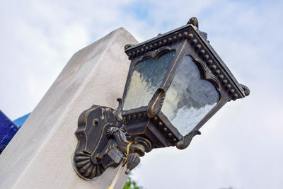 Low angle view of cross against sky